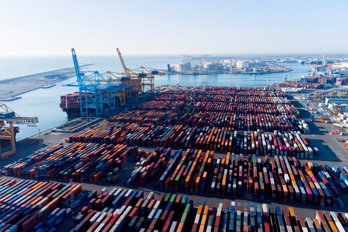 Aerial view of shipping containers and cargo ships in a seaport